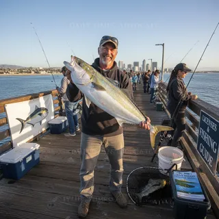 San Diego coastline with fishing piers and boats, showcasing popular fishing locations for anglers.